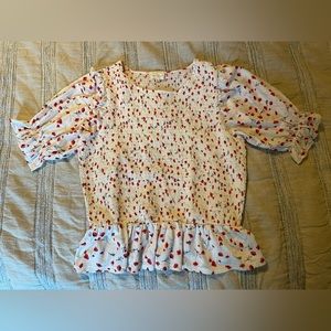 Smocked floral top. White with red and black floral detail.